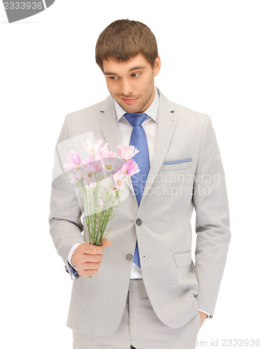 Image of handsome man with flowers in hand