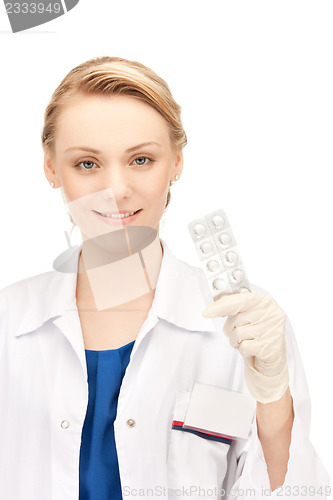 Image of attractive female doctor with pills