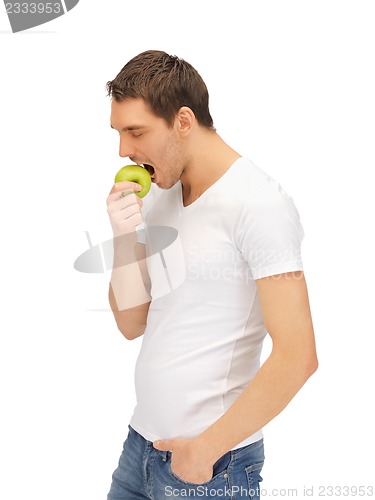 Image of man in white shirt with green apple