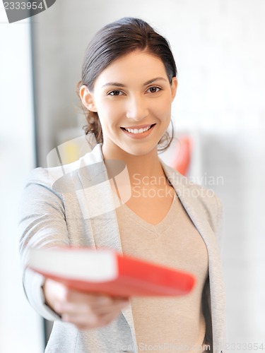 Image of happy and smiling woman with book