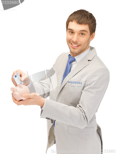 Image of man with piggy bank and money