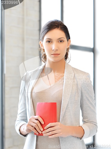 Image of calm and serious woman with book