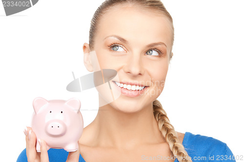 Image of lovely woman with piggy bank