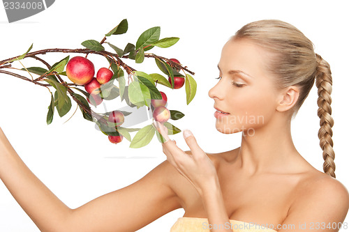 Image of lovely woman with apple twig
