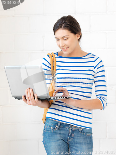 Image of happy teenage girl with laptop computer