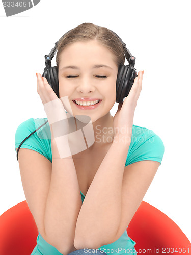 Image of happy teenage girl in big headphones