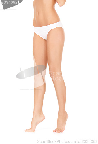 Image of female legs in white bikini panties