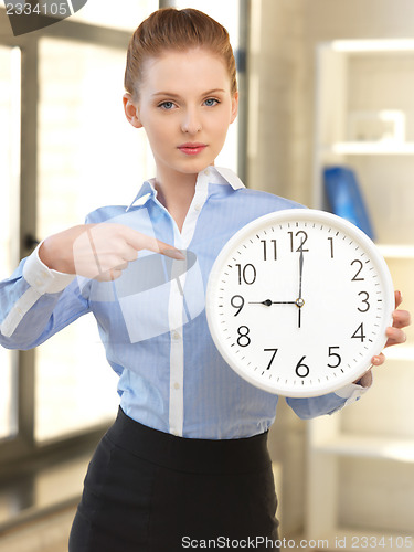 Image of attractive businesswoman with clock