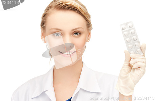 Image of attractive female doctor with pills