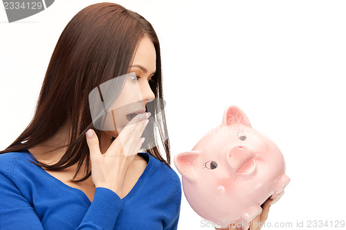 Image of lovely woman with piggy bank