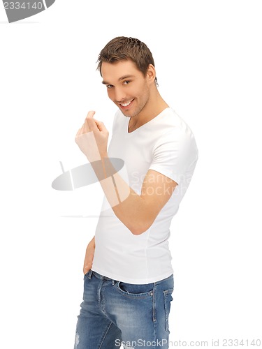 Image of man in white shirt making inviting gesture