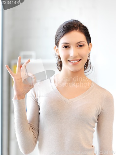 Image of lovely teenage girl showing ok sign
