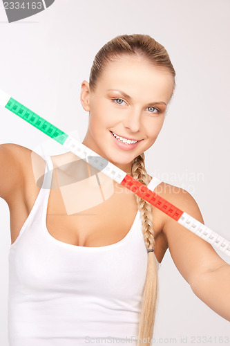 Image of young beautiful woman with measure tape