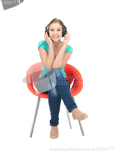 Image of happy teenage girl in big headphones