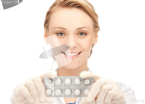 Image of attractive female doctor with pills