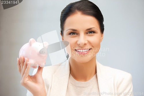 Image of lovely woman with piggy bank