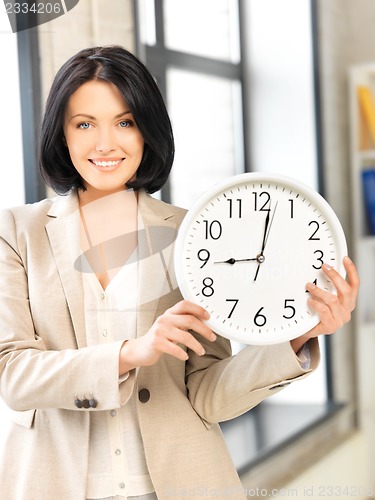 Image of businesswoman with clock