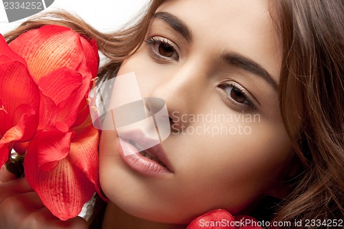 Image of lovely woman with red flowers