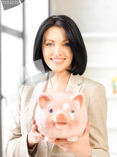 Image of lovely woman with piggy bank