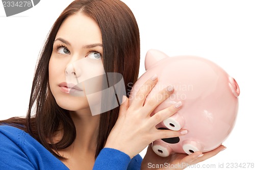 Image of lovely woman with piggy bank