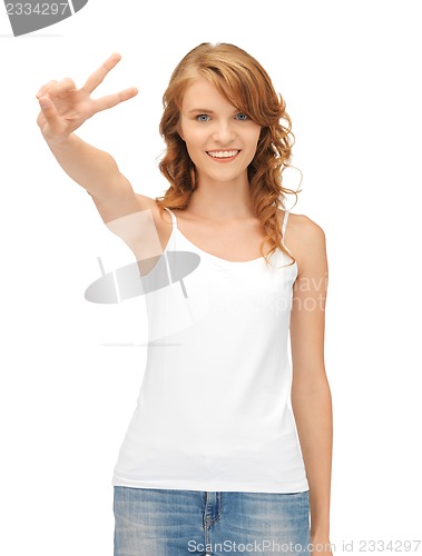 Image of girl in blank white t-shirt showing victory sign