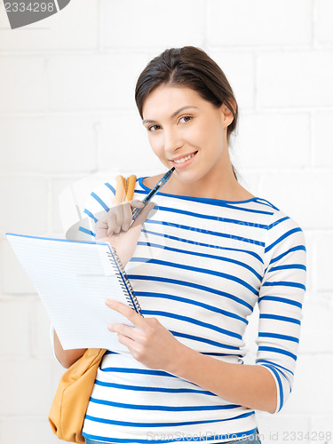 Image of happy woman with big notepad