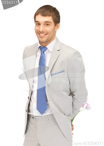 Image of handsome man with flowers in hand