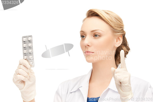 Image of attractive female doctor with pills