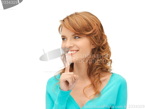 Image of teenage girl with finger on lips