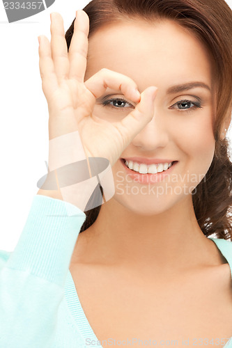 Image of lovely woman looking through hole from fingers