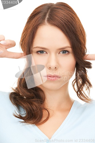 Image of woman with fingers in ears