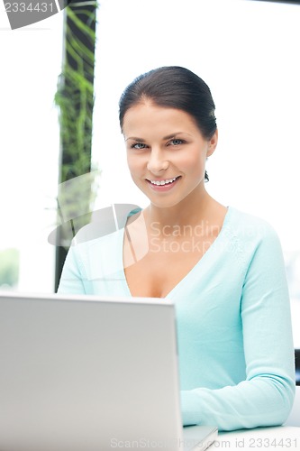 Image of happy woman with laptop computer