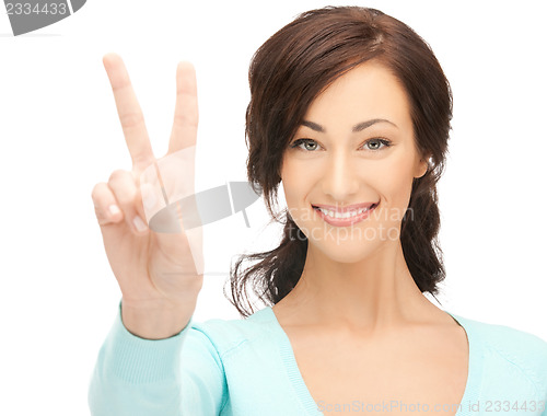 Image of young woman showing victory sign