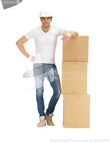 Image of handsome builder with big boxes