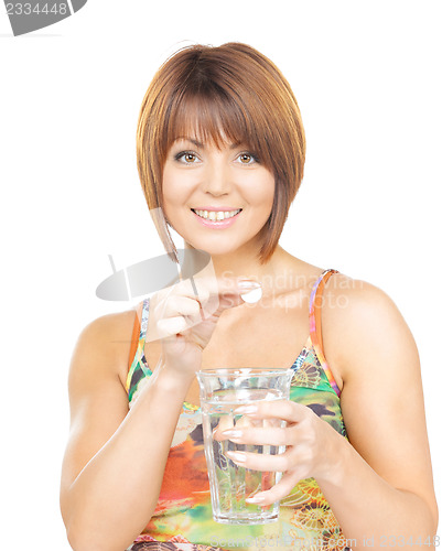 Image of woman with pill and glass of water