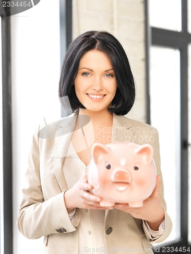 Image of lovely woman with piggy bank