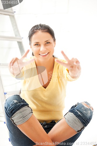 Image of lovely housewife making repairing works