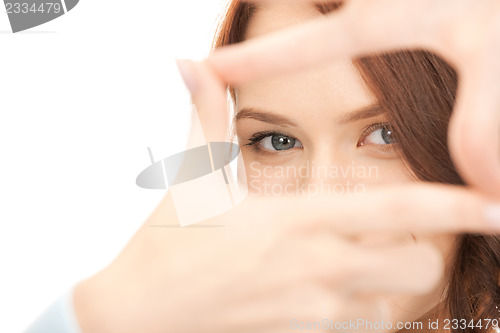 Image of lovely woman creating a frame with fingers