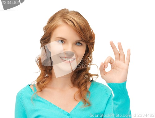 Image of teenage girl showing ok sign