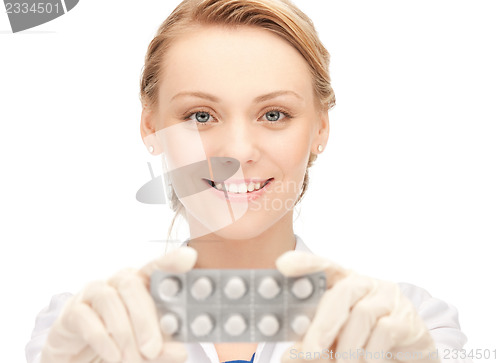 Image of attractive female doctor with pills