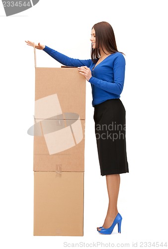 Image of attractive businesswoman with big boxes