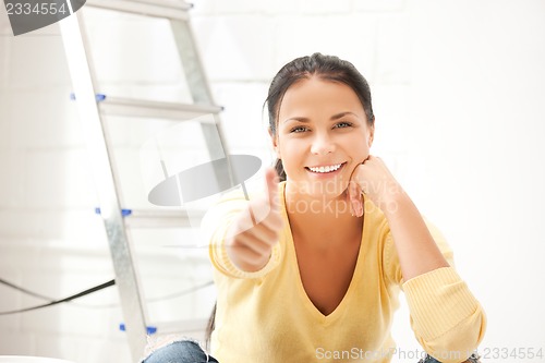 Image of lovely housewife making repairing works