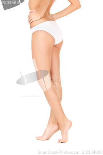 Image of female legs in white bikini panties