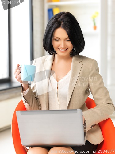Image of happy woman with laptop computer