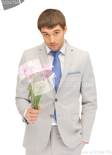 Image of handsome man with flowers in hand