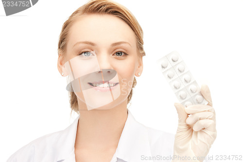 Image of attractive female doctor with pills