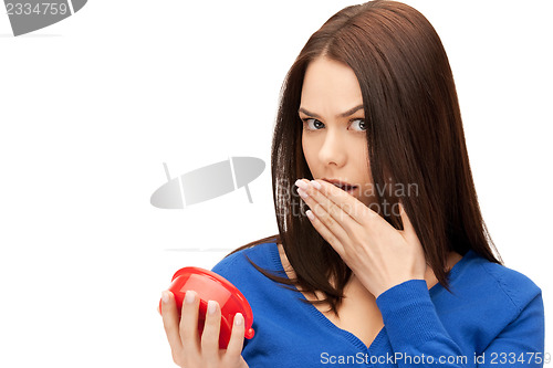 Image of woman holding alarm clock