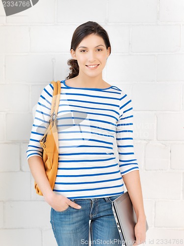 Image of happy and smiling teenage girl with laptop