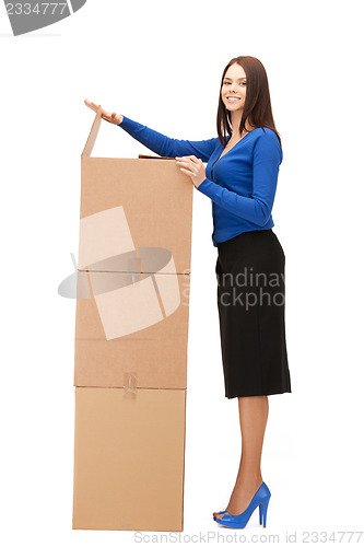 Image of attractive businesswoman with big boxes