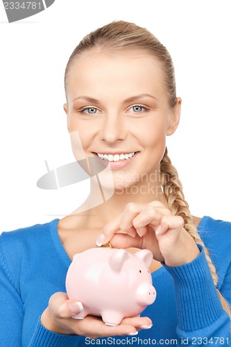 Image of lovely woman with piggy bank and money